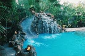 A Pool With A Slide Or Would A Pool With A Splash Pad Be A Better Option Pool Waterfall Dream Pools Cool Pools