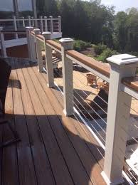 Lighted Deck Rail Posts And Cable Inserts Provide A Contemporary Style To This Low Maintenance Trex Deck Outdoor Stair Railing Deck Railings Building A Deck