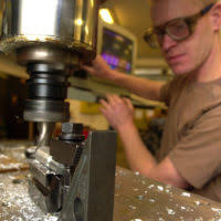 US Air Force (USAF) STAFF Sergeant (SSGT) Welby Torres, assigned as a  Vehicle Management Craftsman, 99th Logistic Readiness Squadron (LRS), wears  his protective hood and clothing as he welds pieces of metal