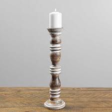 Each one is designed with a segmented body, a knotted rope, gray and white finishes, and starfish embellishments. White Washed Wooden Ribbed Candle Holder 18 In Kirklands