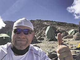 Arnett climbs Kilimanjaro with weight of cancer survivors, loved ones lost 