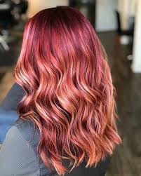 Caramel highlights look perfect on a berry base to create a tonal look. Red Hair With Blonde Highlights