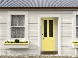 Cottage Style House With Yellow Door And Planter Box With A Dark Metal Roof Yellow Front Doors Front Door Cottage Style Homes