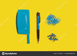 Blue Hole Puncher Pen And Paper Clips Stock Photo