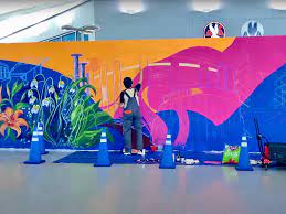 Phase 2 of my live mural painting. I'm into a rhythm now and ideas and  energy is flowing. As many people pass through the terminal and also stop  to visit, I start
