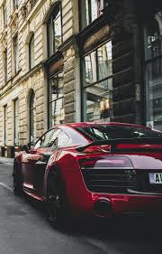 Red And Black Audi R8 Coupe Parked Near Gray Concrete Building Free Stock Photo