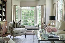 Roller shades are used on the windows with radiators, while drapers are used for the glass doors. Living Room Bay Window With Black Chaise Lounge Bench Transitional Living Room