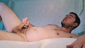 Hairy man stroking his thick uncut cock to cumshot