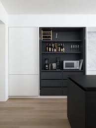 As With Many Economical Projects The Team Turned To Ikea For Its Storage Needs The Architects Ikea Kitchen Design Modern Kitchen Design Black White Kitchen