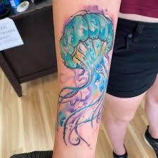 It includes a black ink outlined jellyfish filled with different watercolors like blue. Human Canvas Tattoo Studio Tattooing In Fredericksburg Virginia
