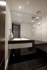 Cluster Of Three Crystal Glass Pendant Lights Creates A Statement In This Modern Bathroom Bathroom Pendant Lighting Bathroom Pendant Modern Bathroom