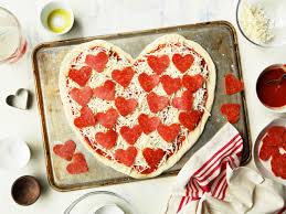 Heart shaped italian pizza for diet food lies in a pizzeria on a table strewn with flour for valentine's day. How To Make A Heart Shaped Pizza Food Com
