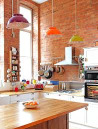 The creamy orange cabinets and lamp complement the greens in the rug, while the fruit bowls tie in the space as a unique (and edible) accent. 50 Trendy Eclectic Kitchens That Serve Up Personalized Style