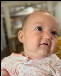 Baby's clothing suggests earlier birthdate