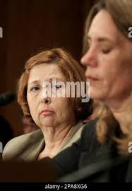 Former KBR/Halliburton contractor Mary Beth Kineston, left, listens as  fellow former contractor Dawn Leamon testifies