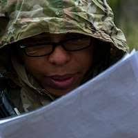 U.S. Army Sgt. Eric Spaeth uses his head to push the