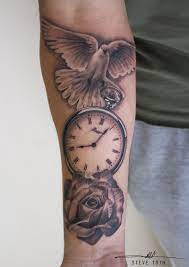 The clock is numbered in roman numerals. Dove Clock Rose Tattoo Steve Toth Clock And Rose Tattoo Watch Tattoos Watch Tattoo Design
