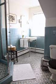 The wall facing the vanity is painted in light blue to match the floor while the white color used for the rest of the setup completes the heavenly look. Vintage Blue Tile Bathroom Via Meet Me In Philadelphia Blue Bathroom Tile Vintage Blue Tile Bathroom Old Blue Tile Bathroom