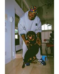 Shaquille O'Neal smiles for a picture with his dog at his home in Orlando,  Florida, 1995. Photo by Andrew D. Bernstein/NBAE via Getty Images.