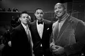 Trevor Noah - One person in this picture works hard in the gym. The other person has an Oscar and the Rock is wearing a cool suit. Rami Malek Dwayne The Rock