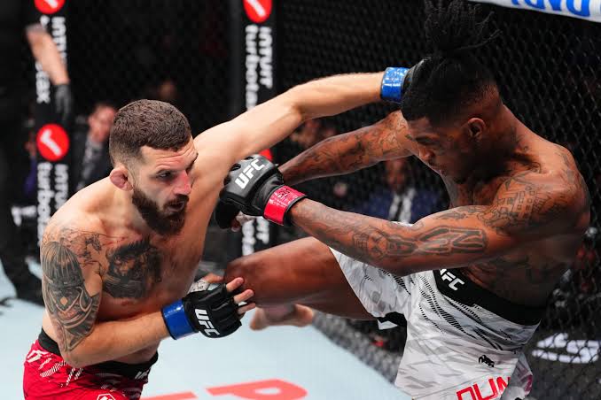 Sedriques Dumas throwing a kick in the Octagon