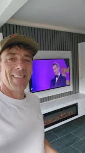 Full wall media wall with custom storage cabinets, electric fireplace and  TV panel all mounted