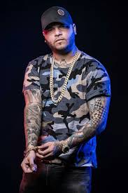 Farruko poses with one of his cars. 26 Farruko Ideas Reggaeton Best Music Artists Tattoo Samples