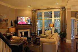 It is a large sunken living room with cathedral ceilings, a corner fireplace and a wall of windows with a water view. Living Room With Corner Fireplace Decorating Ideas Popular In Spaces Kitchen Trop Corner Fireplace Living Room Fireplace Furniture Placement Living Room Corner