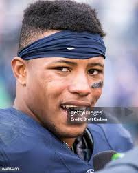 Kyle Ritz and Jovann Letuli of the Akron Zips hold off Joey Julius of...  News Photo