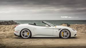 Chrome magenta w/black 'cal custom' on windshield w/yellow rr's: Ferrari California T Hits The Shoreline Wearing Custom Alloys Carscoops
