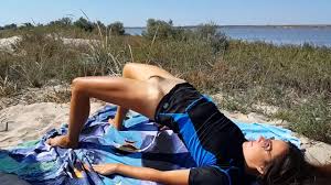 Bottomless MILF gets fucked doing nude yoga on the public beach