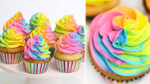 These gorgeous rainbow cupcakes feature layers of sponge topped with buttercream icing and sprinkles. How To Make Rainbow Swirl Cupcakes Rainbow Buttercream Technique Rainbow Cupcakes Recipe Youtube