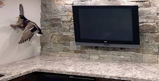 The rustic style on this basement bar is formed from the reclaimed wood ceiling. Basement Bar Design Interior Stone Veneer Modern Rustic Field Ledge Stone Buechel Stone