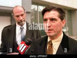 Defense attorney John Renzulli, right, representing such handgun makers as  Smith & Wesson Corp., Colt's Manufacturing Co., Sturm, Ruger and Co.,  speaks to the media as co-council Tim Atwood looks