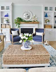 This living area is painted in blue and features lots of blue pillows in different shades. New Blue And White Living Room Updates Sand And Sisal White Living Room Decor Blue And White Living Room White Family Rooms
