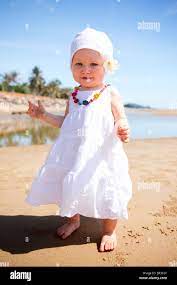 Cute Baby Girl In White Summer Dress On The Beach Stock Photo Alamy