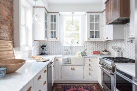 The white diamond backsplash opens up space! White Kitchen Cabinets With White And Gray Diamond Pattern Marble Tiles Transitional Kitchen