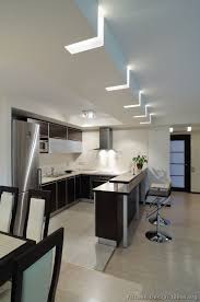 Highlight the curves to the side or the ceiling panels. Kitchen Idea Of The Day Modern Two Tone Kitchen With Unique Ceiling Lighting Kitchen Ceiling Design Kitchen Ceiling Lights Modern Minimalist Kitchen Design