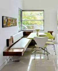 Corner dining nook is filled with a freestanding gray upholstered curved dining banquette lined with colorful silk pillows facing an oval saarinen dining table lined with saarinen tulip side chairs illuminated by an iron sphere pendant light. 80 Banquette Dining Table Ideas Banquette Dining Banquette Interior