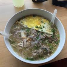 The counter where customers order, the open kitchen and seating in the form of small tables as. Soupa Saiyan
