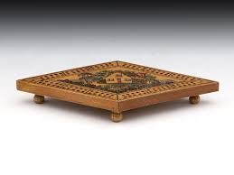The cribbage board bottom has a slot channel for storage pegs while maintaining a seamless design. Tunbridge Ware Cribbage Board