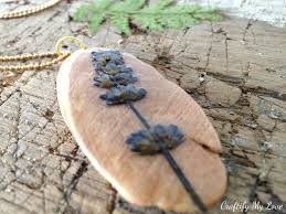Have you ever thought of making wood flowers from wood peel here is a creative flower making tutorial to craft beautiful flowers. Diy Pressed Flowers Pendant Using A Driftwood Base Craftify My Love