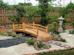 This Japanese Garden Decorated With Japanese Pagoda Decor And A Wooden Garden Bridge Japanese Garden Backyard Japanese Garden Garden Bridge