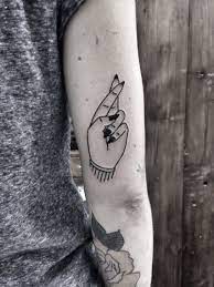 Crossed Fingers Tattoo By Jennifer Lawes Tattoos Finger Tattoos Word Tattoos