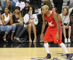 Rihanna sits courtside as chris brown plays in charity basketball match, singer looks seriously unimpressed: The Bajan Reporter Awkward Chris Brown Rihanna Reunion Entv Update The Bajan Reporter