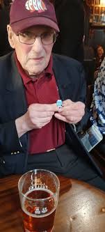 Peter Chutter, sporting the new wood fest badge, advertising the bash at  the Musical Museum He is with fellow Campden Hill SPBW members in the  Churchill Arms in Kensington.