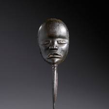 In the style of. Small anthropomorphic mask with beak in hardwood with  black patina.