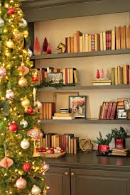 Scale down with a small tree. Christmas Bookshelf Styling Tips
