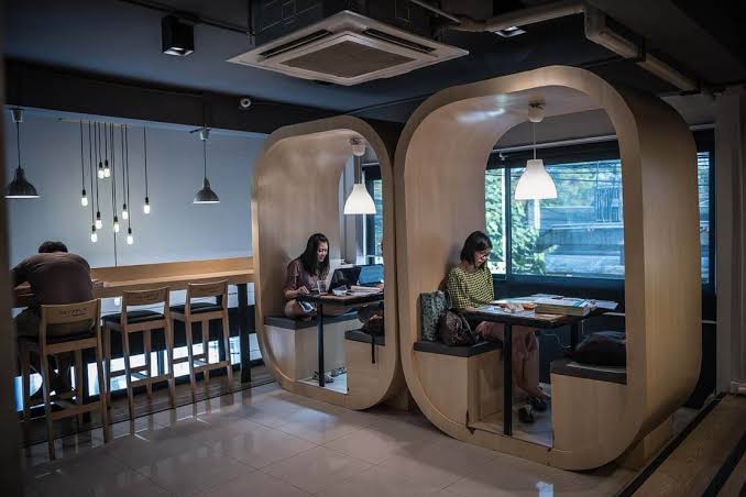 People working from a laptop-friendly cafe