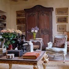 A Large Armoire Dominates One Wall Of The Living Room Mismatched Living Room Furniture French Country Furniture Interior